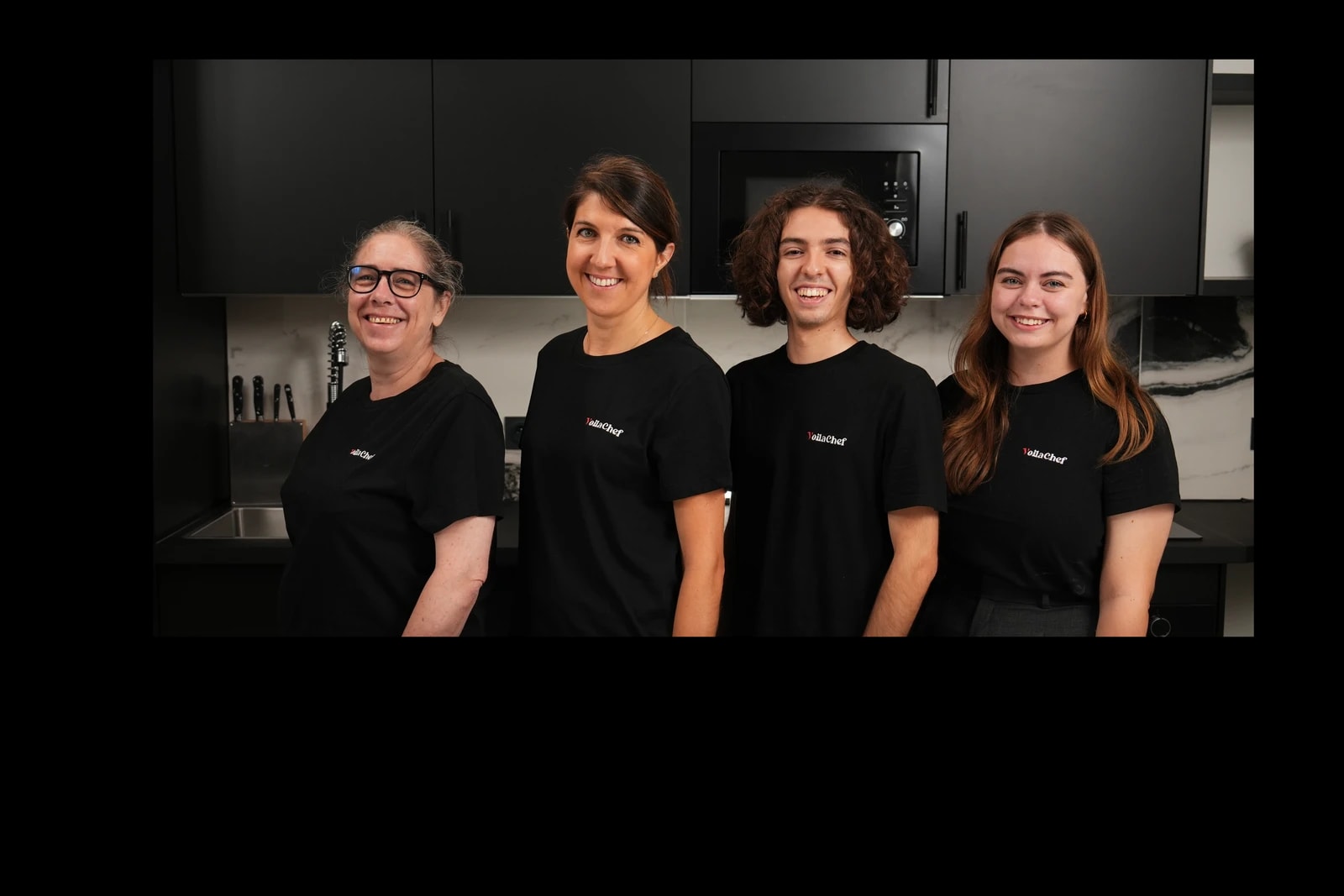 Sandra, Sophie, Lucas and Fleur, members of the VoilaChef team, together in a professional kitchen